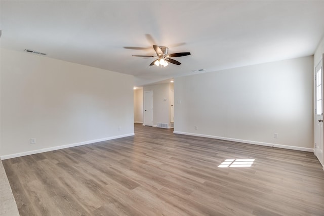 spare room with ceiling fan and light wood-type flooring