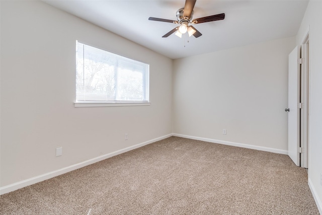 carpeted spare room with ceiling fan