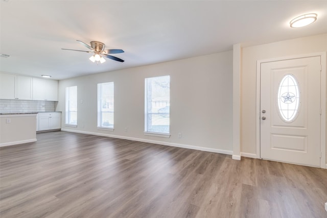 entryway with ceiling fan and light hardwood / wood-style flooring