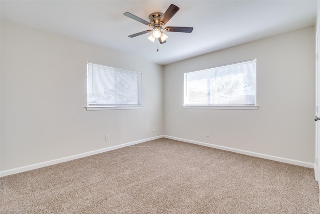 carpeted empty room featuring ceiling fan