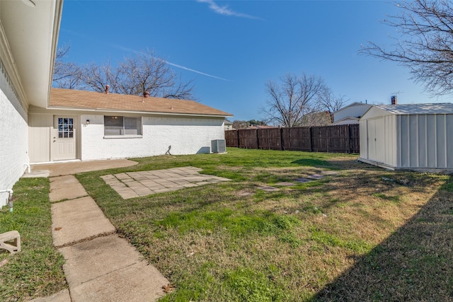 view of yard featuring a patio, a shed, and central AC unit