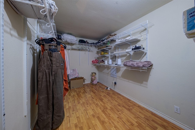 laundry room featuring hardwood / wood-style floors and a textured ceiling