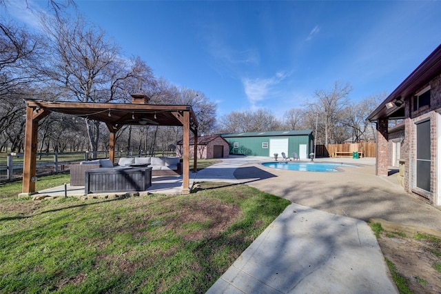 view of yard featuring a storage shed, an outdoor living space, a patio, and a fenced in pool