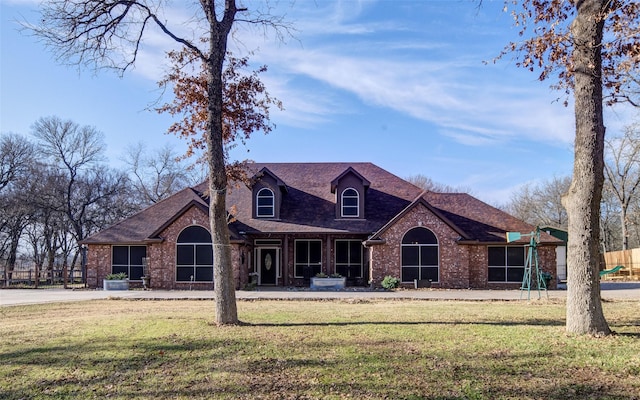 view of front of home with a front yard and a playground