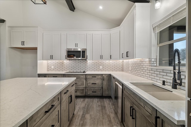 kitchen featuring white cabinets, light stone countertops, and stainless steel appliances