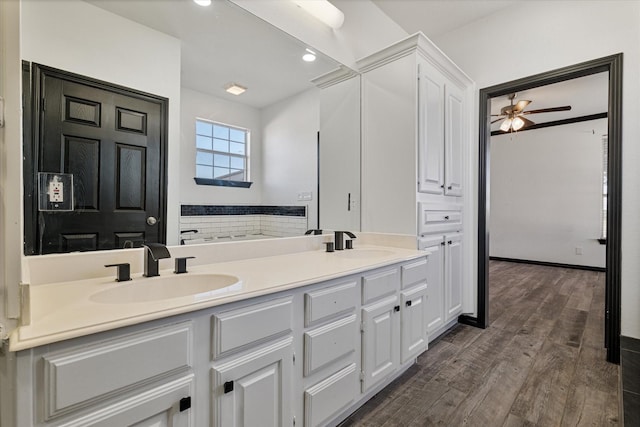 bathroom featuring vanity, ceiling fan, and wood-type flooring