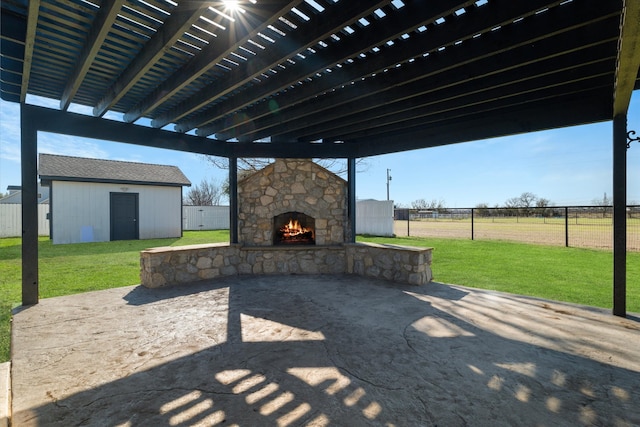 view of patio / terrace with a storage unit, a pergola, and an outdoor stone fireplace