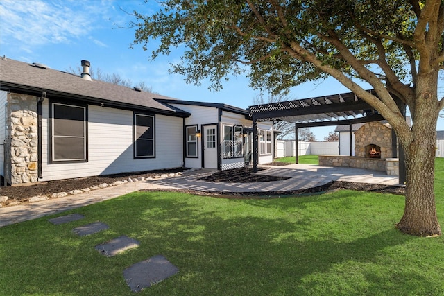 view of yard with a patio, a pergola, and an outdoor stone fireplace