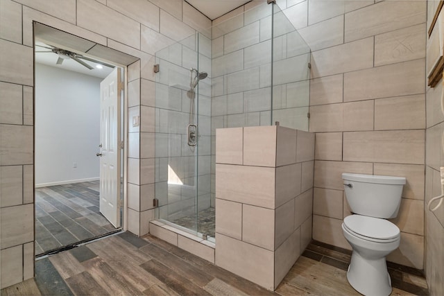 bathroom featuring an enclosed shower and toilet