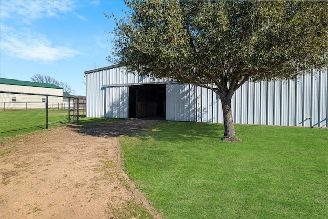 view of outbuilding featuring a lawn