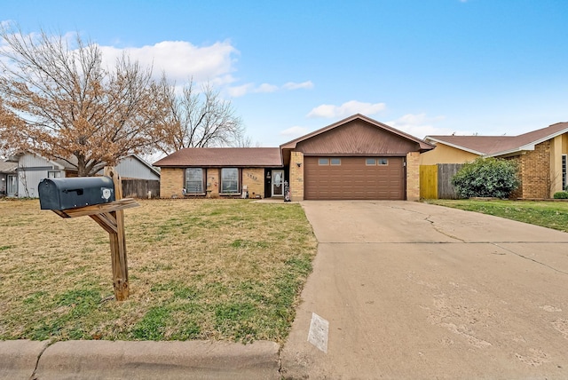 ranch-style home with a garage and a front lawn