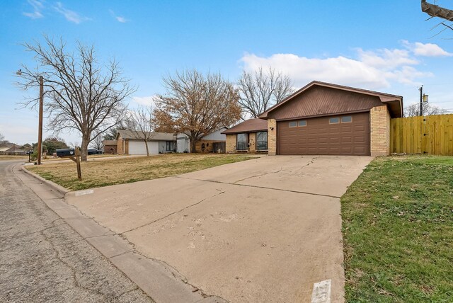 2517 Button Willow Pkwy, Abilene, TX 79606 - single story home featuring fence, a front lawn, brick siding, a garage, and concrete driveway