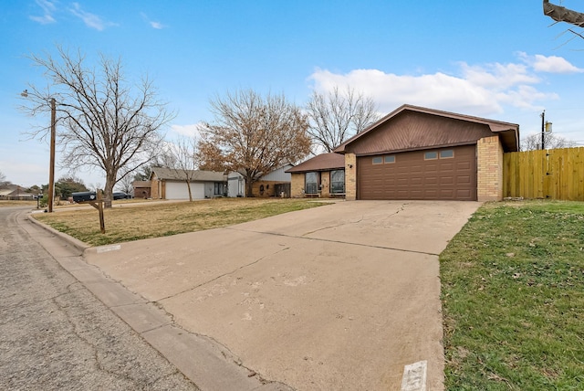 ranch-style house featuring a garage and a front yard