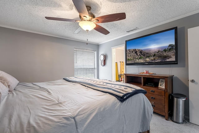 bedroom with light carpet, a textured ceiling, ceiling fan, and ornamental molding