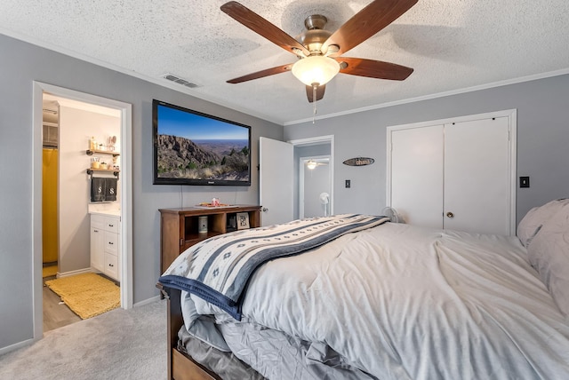 bedroom featuring crown molding, a closet, light colored carpet, ceiling fan, and connected bathroom