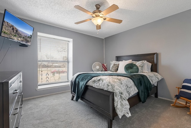 bedroom with ceiling fan, light colored carpet, a textured ceiling, and multiple windows