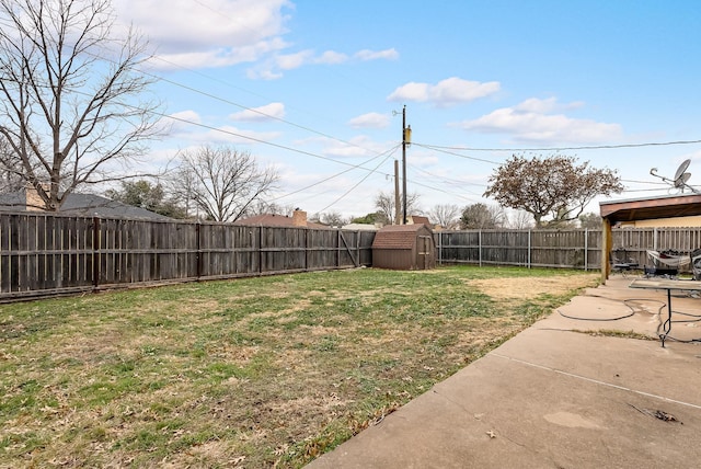 view of yard with a shed and a patio