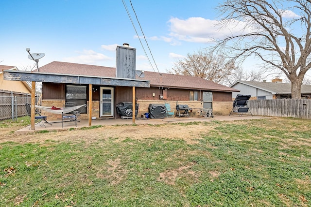 back of house featuring a patio area and a yard