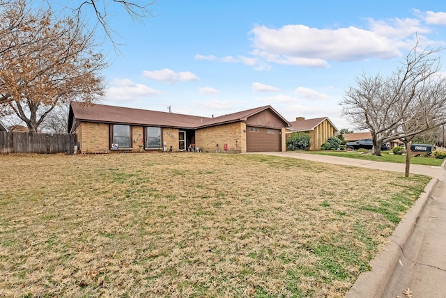 ranch-style home with a front yard and a garage