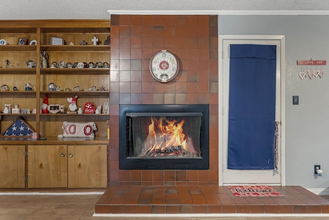 room details with ornamental molding and a tiled fireplace