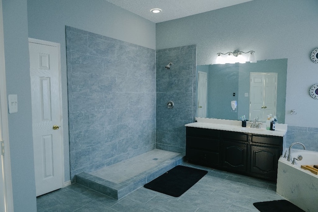 bathroom with tile patterned flooring, vanity, and plus walk in shower