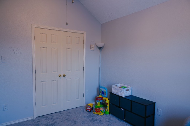 game room with vaulted ceiling, carpet, and a textured ceiling