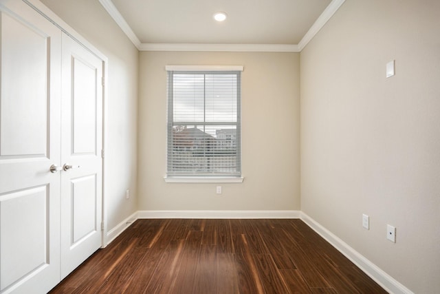 unfurnished room featuring dark wood-type flooring and ornamental molding