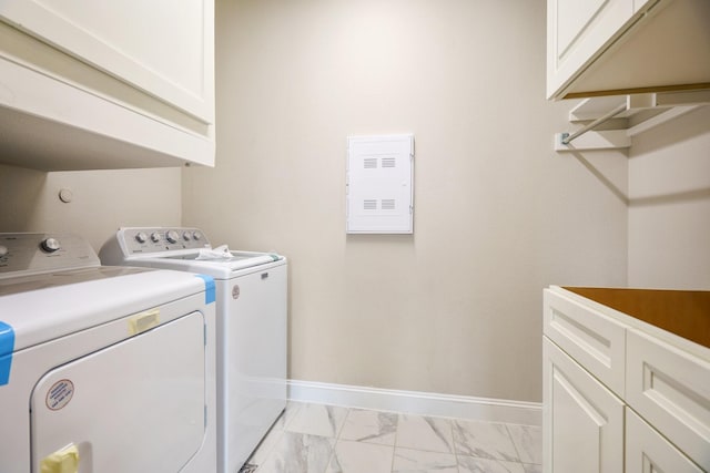 washroom featuring independent washer and dryer and cabinets