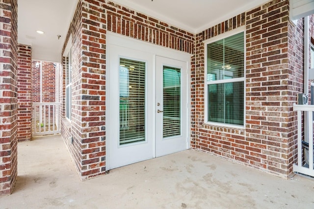 property entrance featuring a patio and french doors