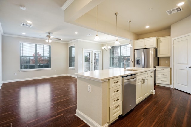 kitchen featuring sink, white cabinets, stainless steel appliances, and an island with sink