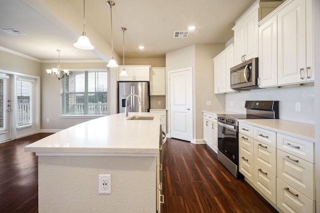 kitchen with white cabinetry, a center island with sink, and stainless steel appliances