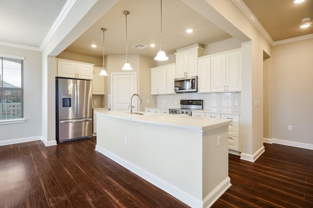 kitchen featuring white cabinets, dark wood-type flooring, stainless steel appliances, sink, and a kitchen island with sink