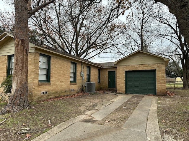 ranch-style house with central AC and a garage