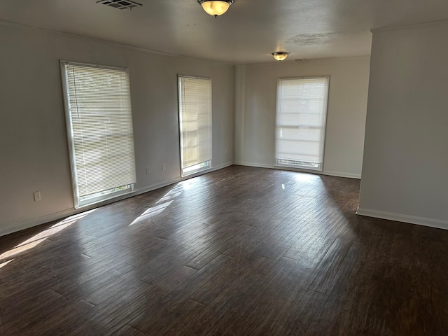 spare room with dark wood-type flooring