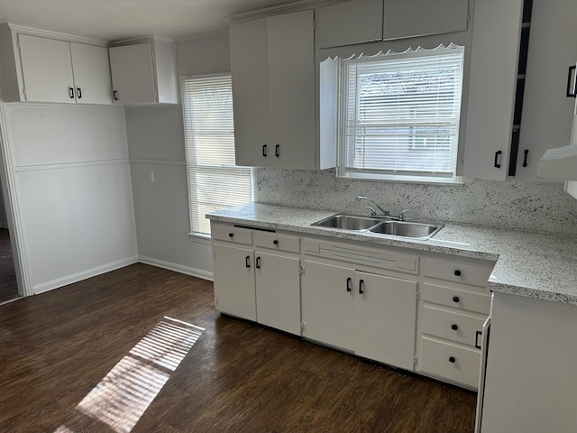 kitchen with sink, white cabinetry, and a wealth of natural light