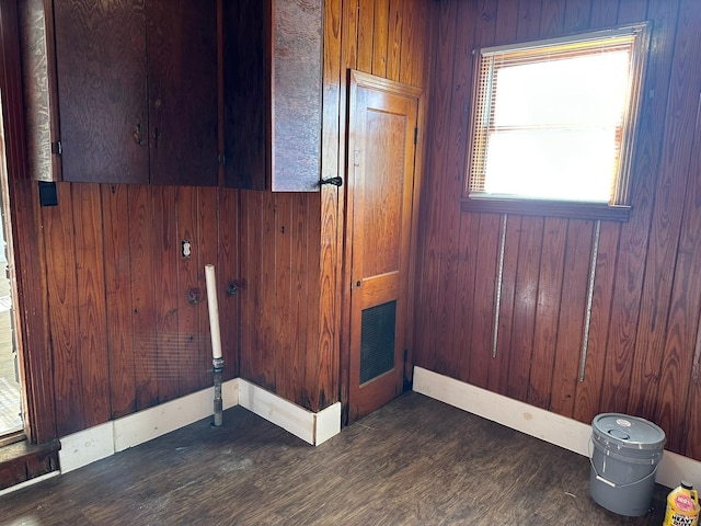 spare room with wood walls and dark hardwood / wood-style flooring