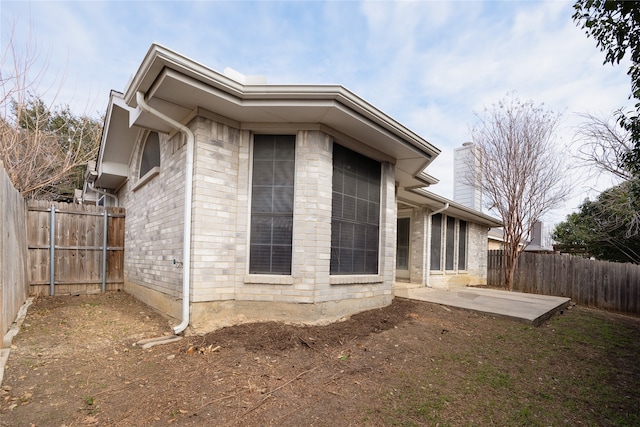 view of property exterior with a patio area