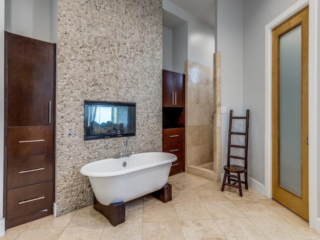 bathroom with tile patterned floors and shower with separate bathtub