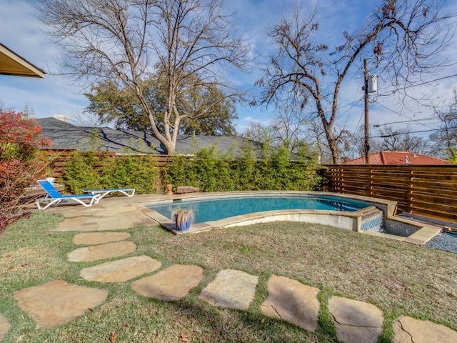 view of swimming pool with a patio, a yard, and a hot tub