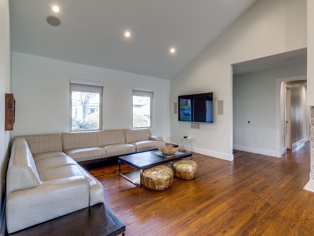 living room with dark hardwood / wood-style floors and high vaulted ceiling