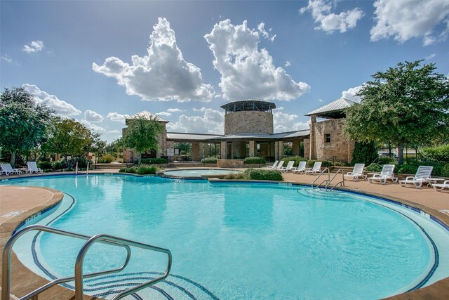 view of swimming pool featuring a patio and a community hot tub