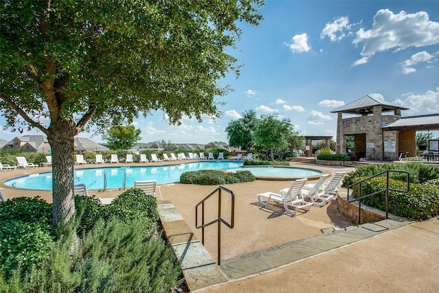 view of swimming pool with a patio