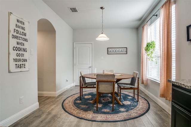 dining space featuring dark wood-type flooring