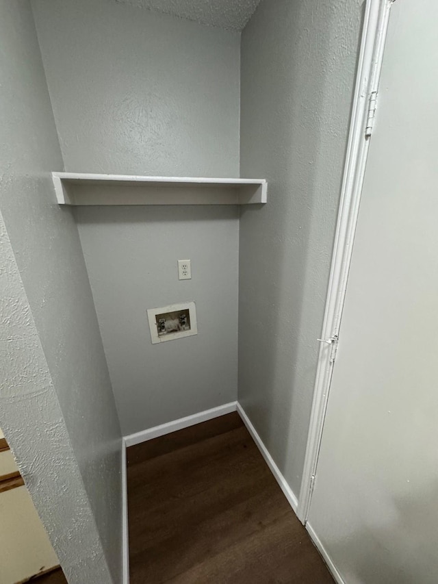 washroom with hookup for a washing machine, a textured ceiling, and dark hardwood / wood-style floors