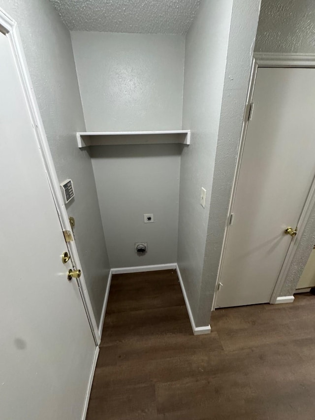 laundry area with electric dryer hookup, hardwood / wood-style flooring, and a textured ceiling