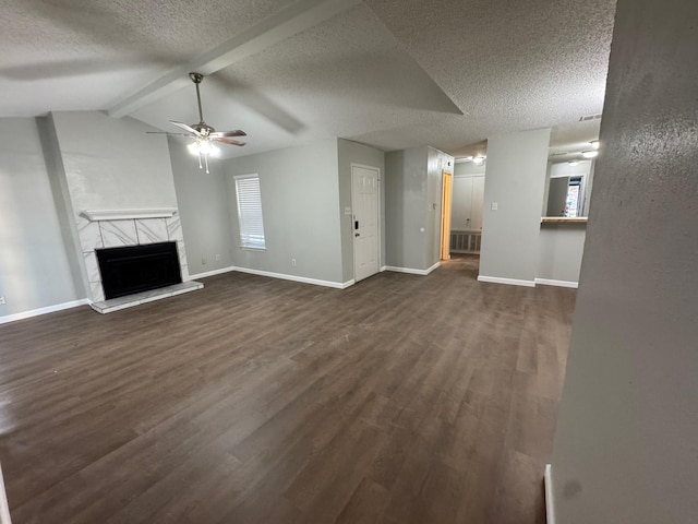 unfurnished living room featuring ceiling fan, a textured ceiling, dark hardwood / wood-style flooring, and vaulted ceiling