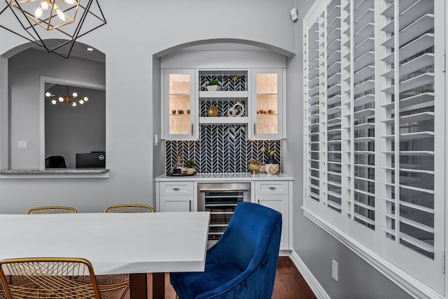 bar with pendant lighting, white cabinetry, dark hardwood / wood-style flooring, and wine cooler