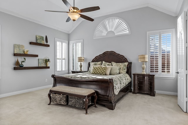 carpeted bedroom with vaulted ceiling, ceiling fan, and ornamental molding