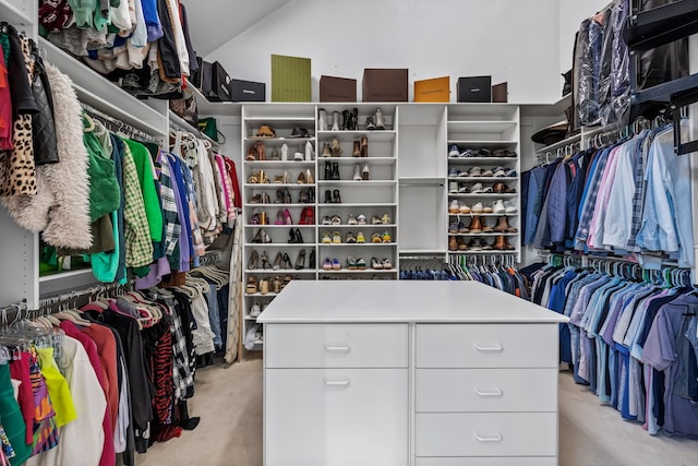 walk in closet featuring light carpet and lofted ceiling