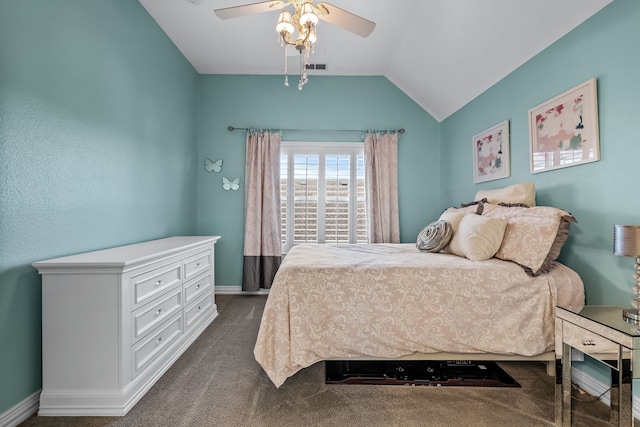 bedroom with ceiling fan, dark carpet, and vaulted ceiling